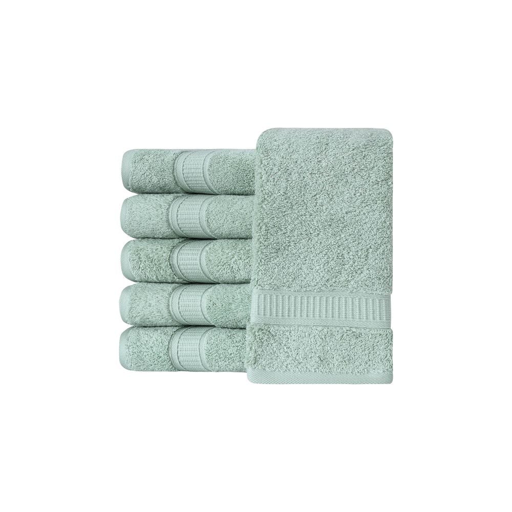 A set of six luxurious Turkish cotton hand towels in various vibrant colors, showcasing their soft texture and elegant dobby border design.