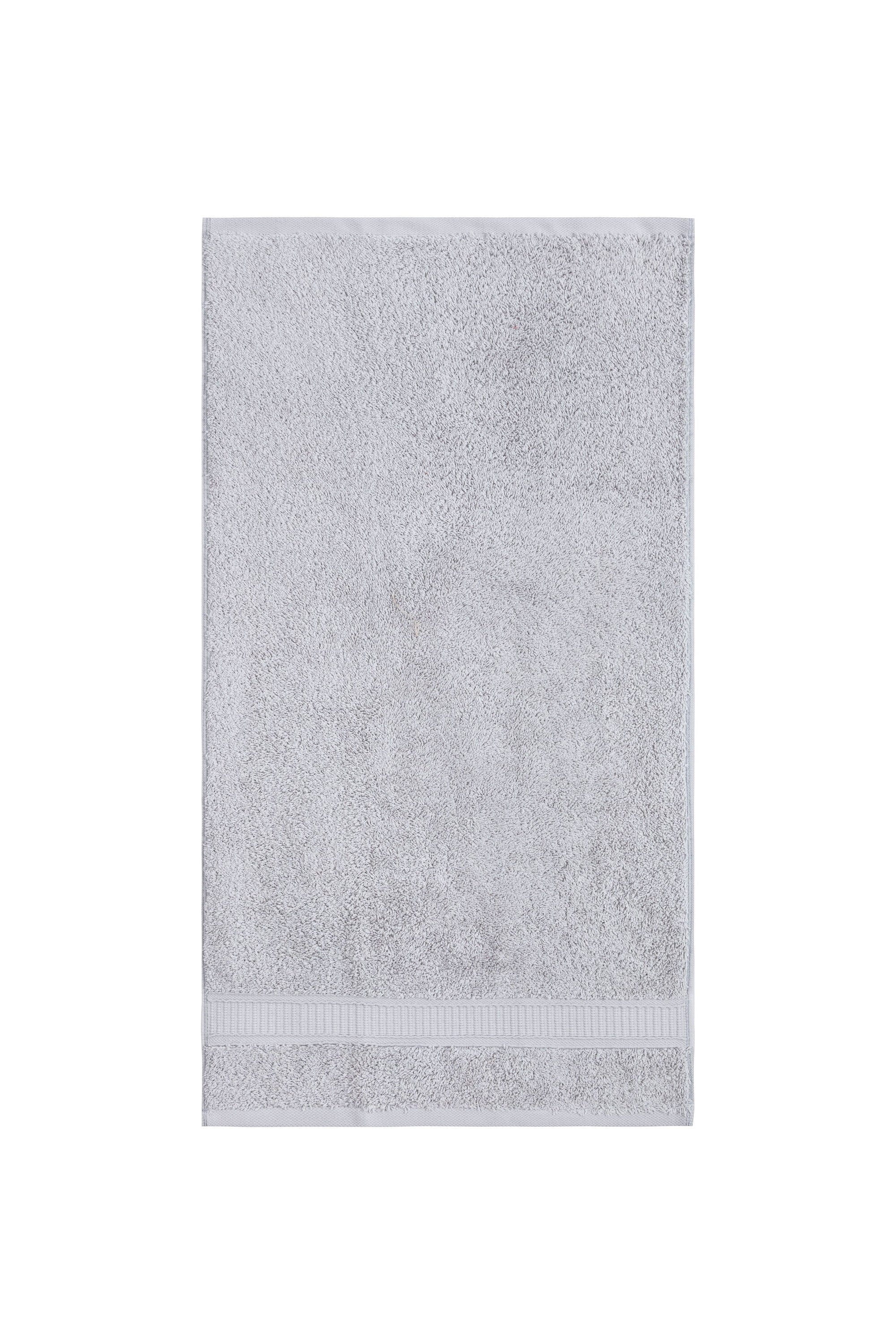 A set of six luxurious Turkish cotton hand towels in various vibrant colors, showcasing their soft texture and elegant dobby border design.