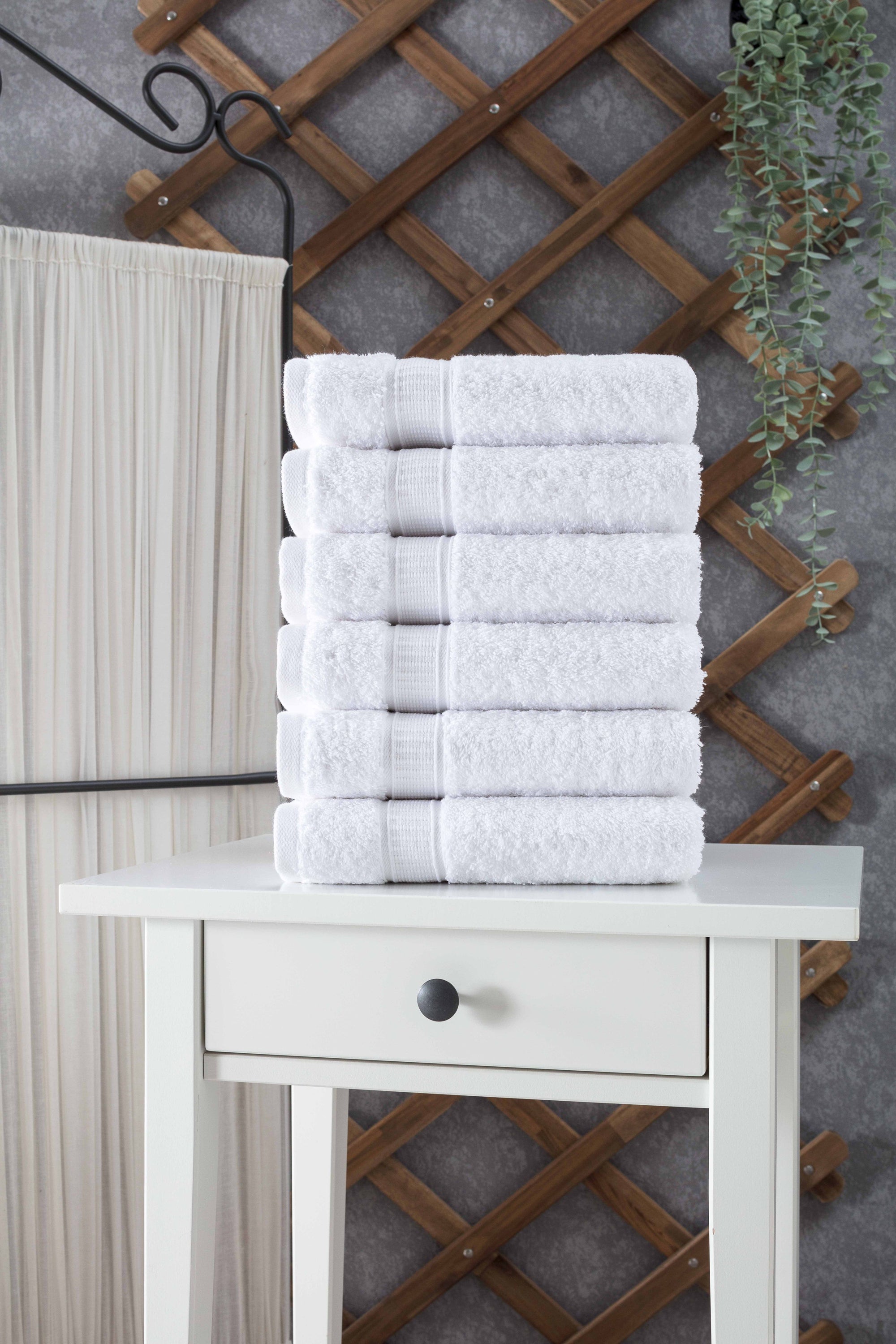 A set of six luxurious Turkish cotton hand towels in various vibrant colors, showcasing their soft texture and elegant dobby border design.