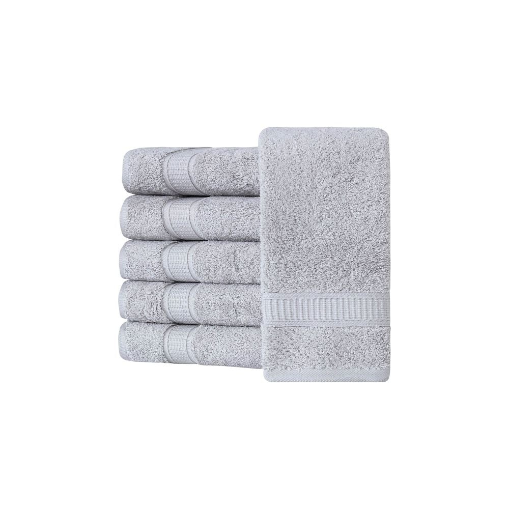 A set of six luxurious Turkish cotton hand towels in various vibrant colors, showcasing their soft texture and elegant dobby border design.