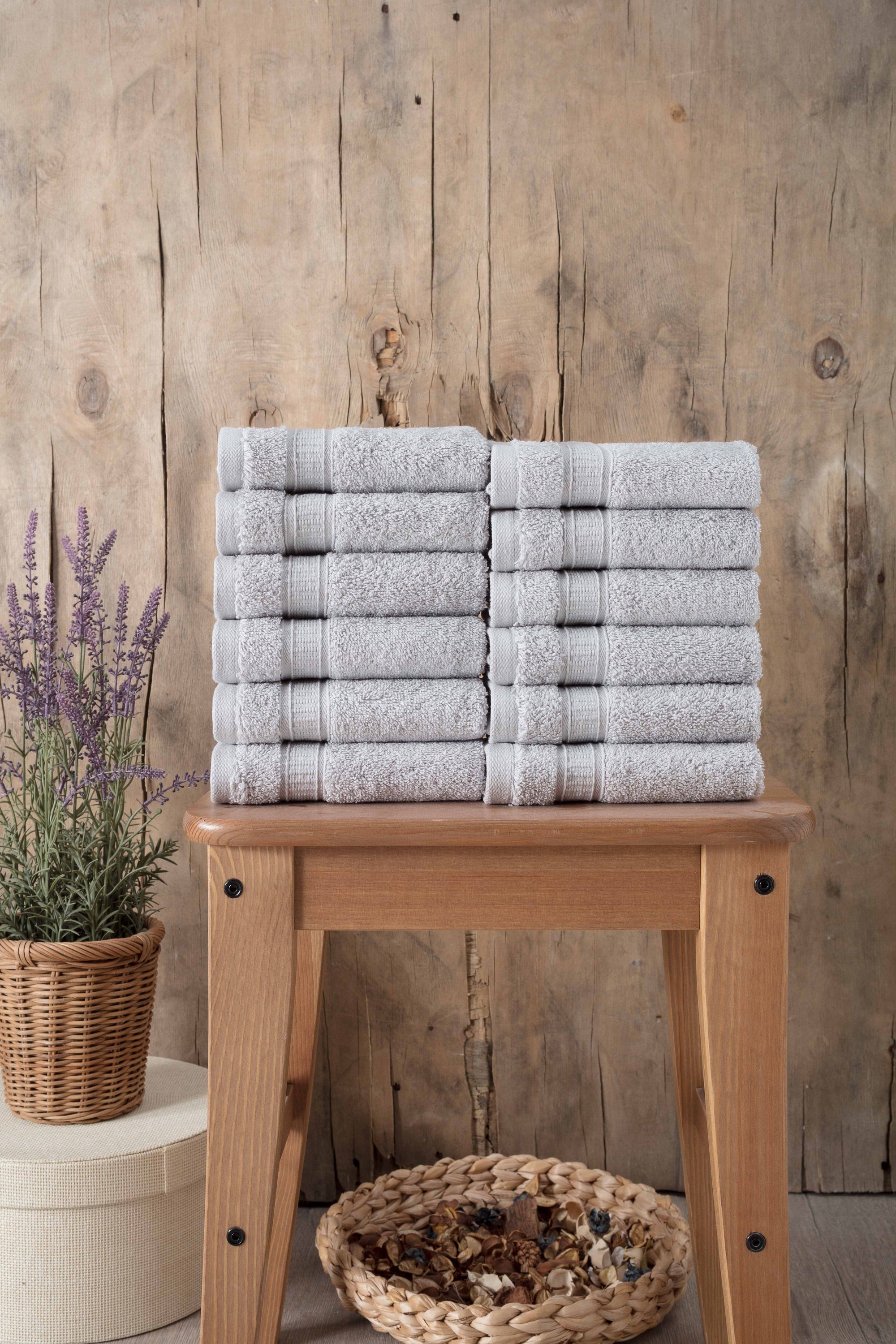 A set of 12 luxurious Turkish cotton washcloths in various vibrant colors, showcasing their softness and dobby border design.