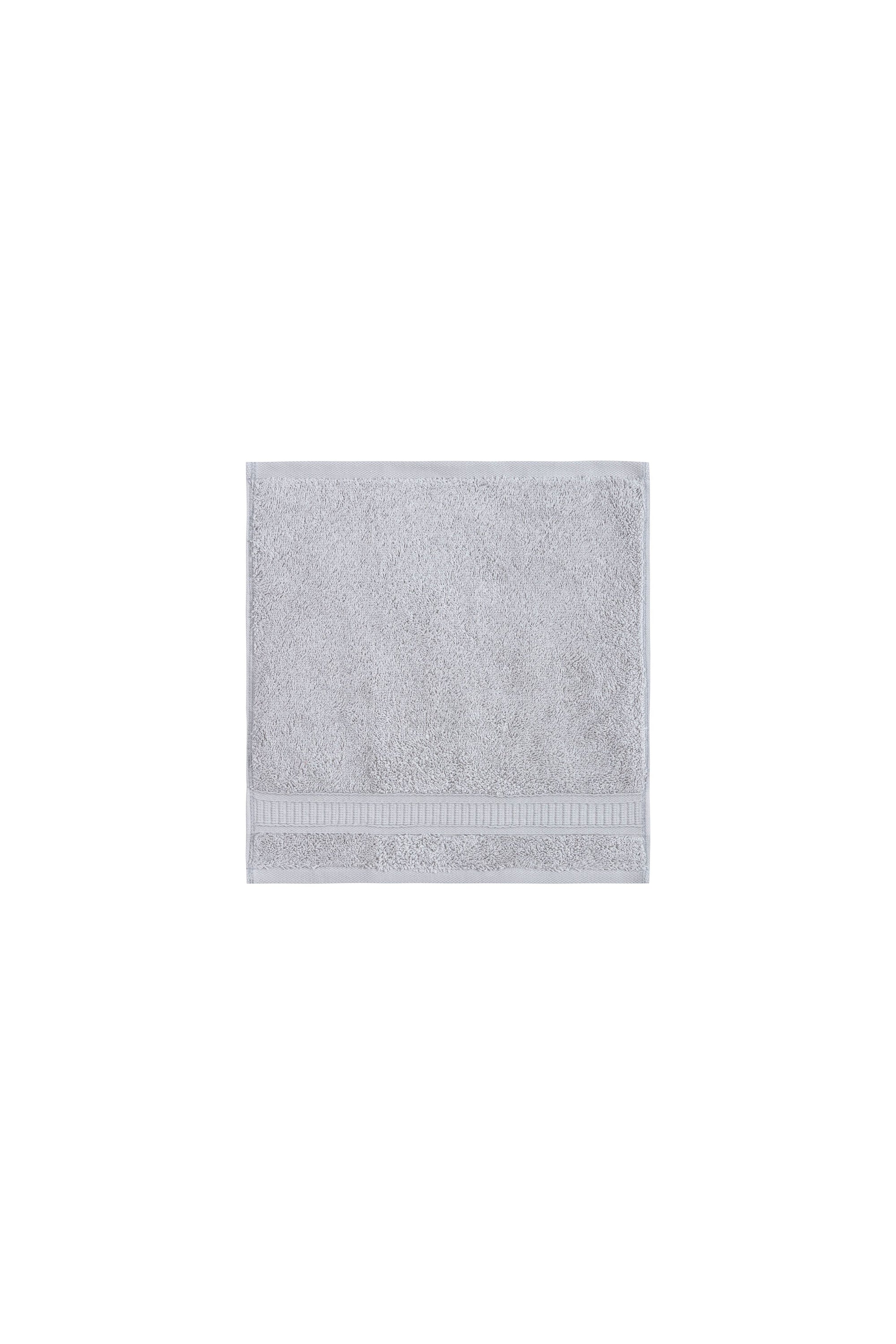 A set of 12 luxurious Turkish cotton washcloths in various vibrant colors, showcasing their softness and dobby border design.