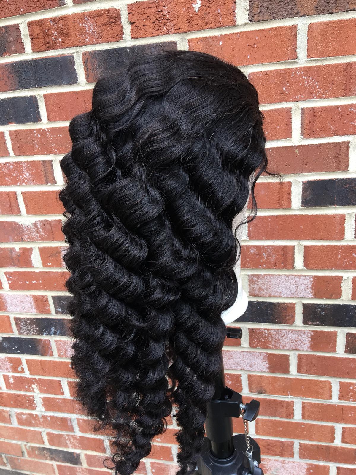 180% Density Full 4x4 Transparent Lace Front Loose Deep Human Hair Wig displayed on a mannequin, showcasing its natural waves and high-quality remy hair.