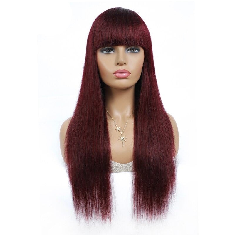 A beautiful #1B/99J Brazilian Straight Human Hair Wig with Bangs, showcasing a rich burgundy color and sleek straight texture.