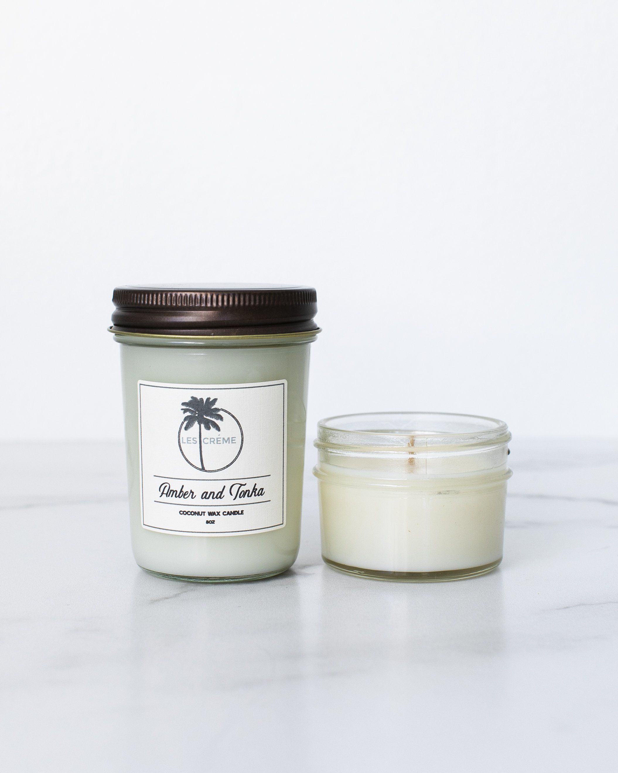 Amber + Tonka Scent Coconut Wax Candle in a stylish glass jar, showcasing its elegant design and natural wax composition.