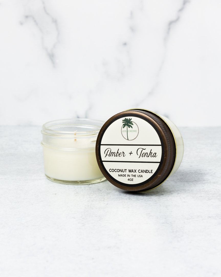 Amber + Tonka Scent Coconut Wax Candle in a stylish glass jar, showcasing its elegant design and natural wax composition.