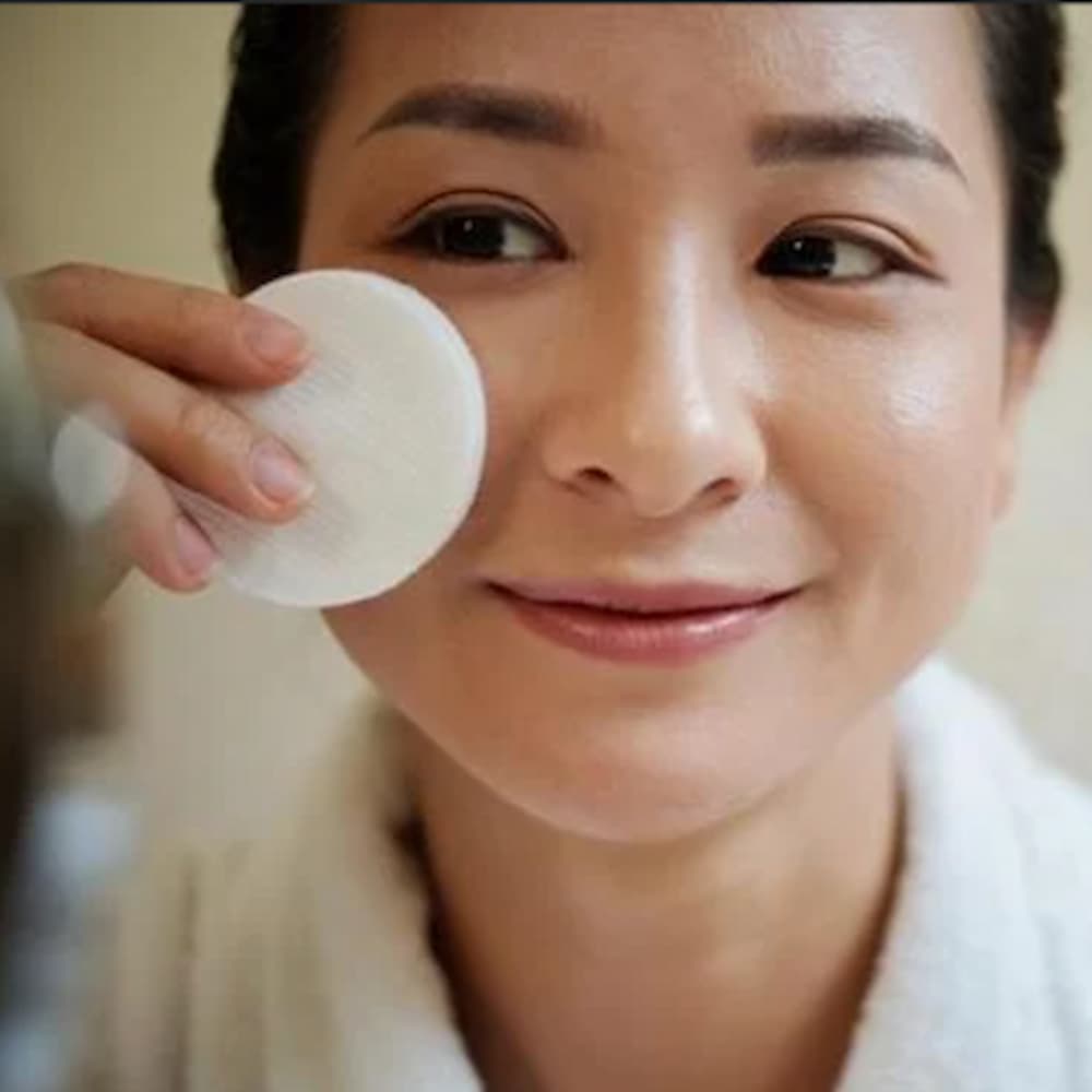 A bottle of Antioxidant Skin Perfecting Toner with a sleek design, featuring natural ingredients like Aloe Vera and Kakadu Plum.