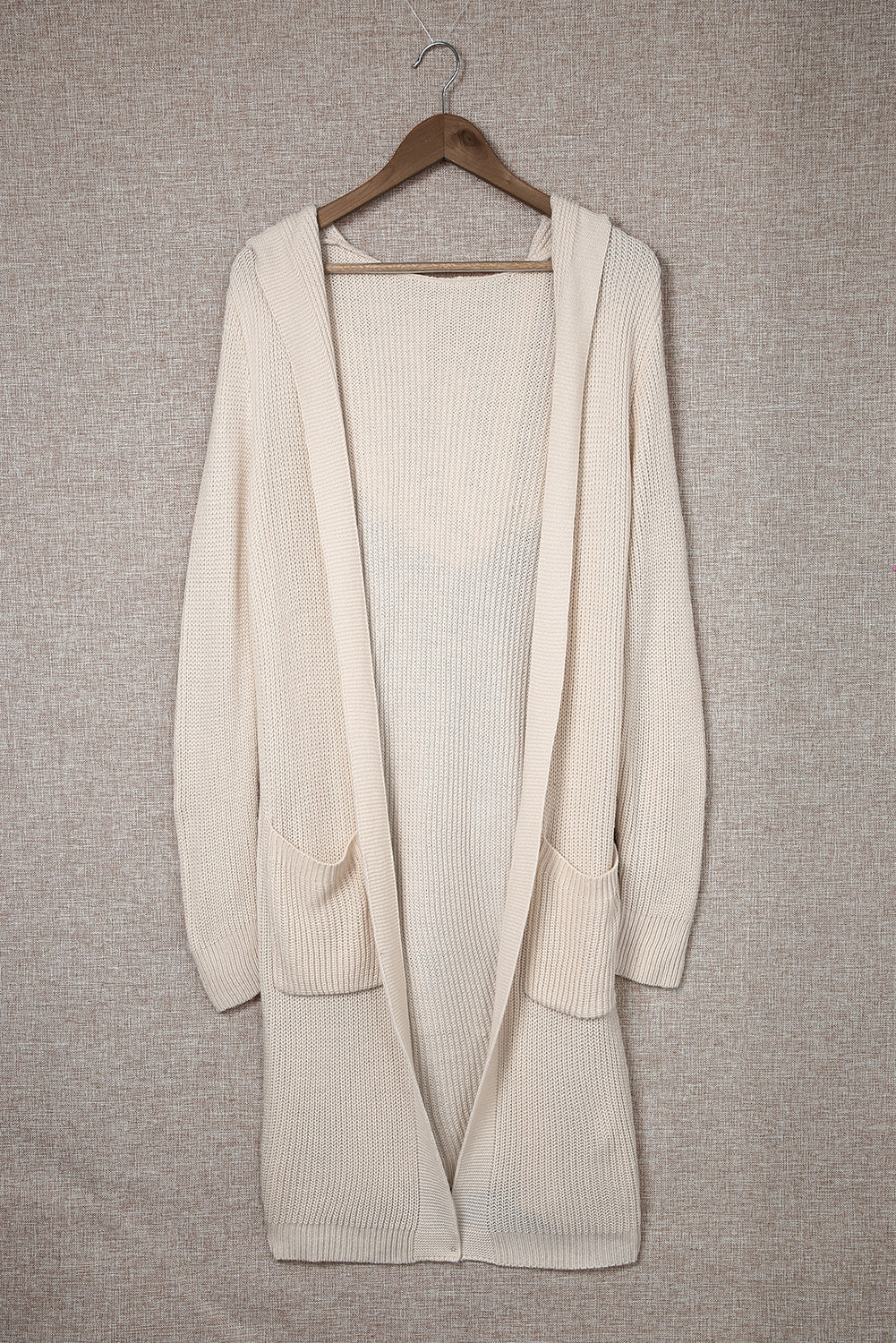 Apricot hooded cardigan with pockets, open front design, stylish knitted fabric, perfect for casual wear.