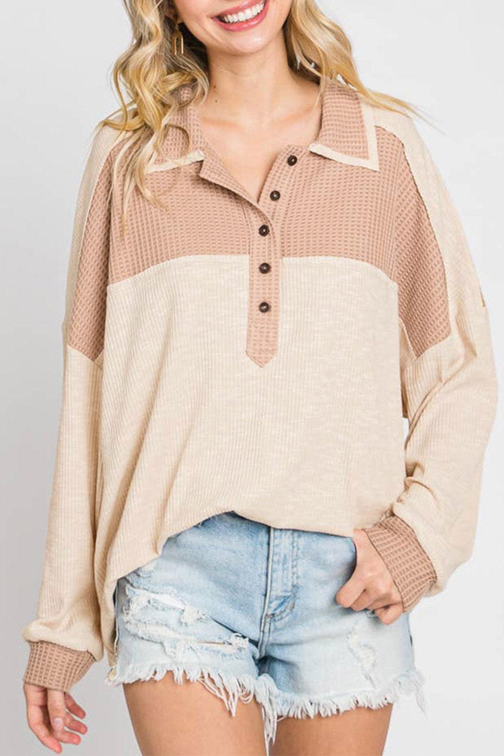 Apricot oversized knit top featuring a waffle contrast design, showcasing a stylish turn-down collar and textured fabric.