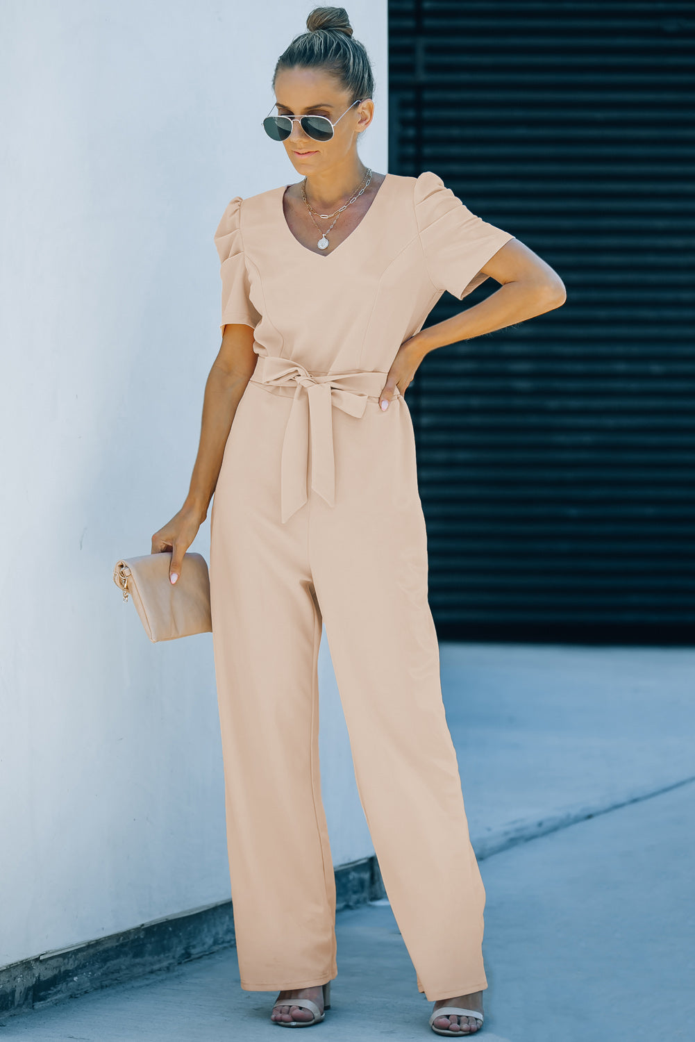 Apricot straight leg jumpsuit with knotted high waist and short sleeves, showcasing a stylish v-neck design.