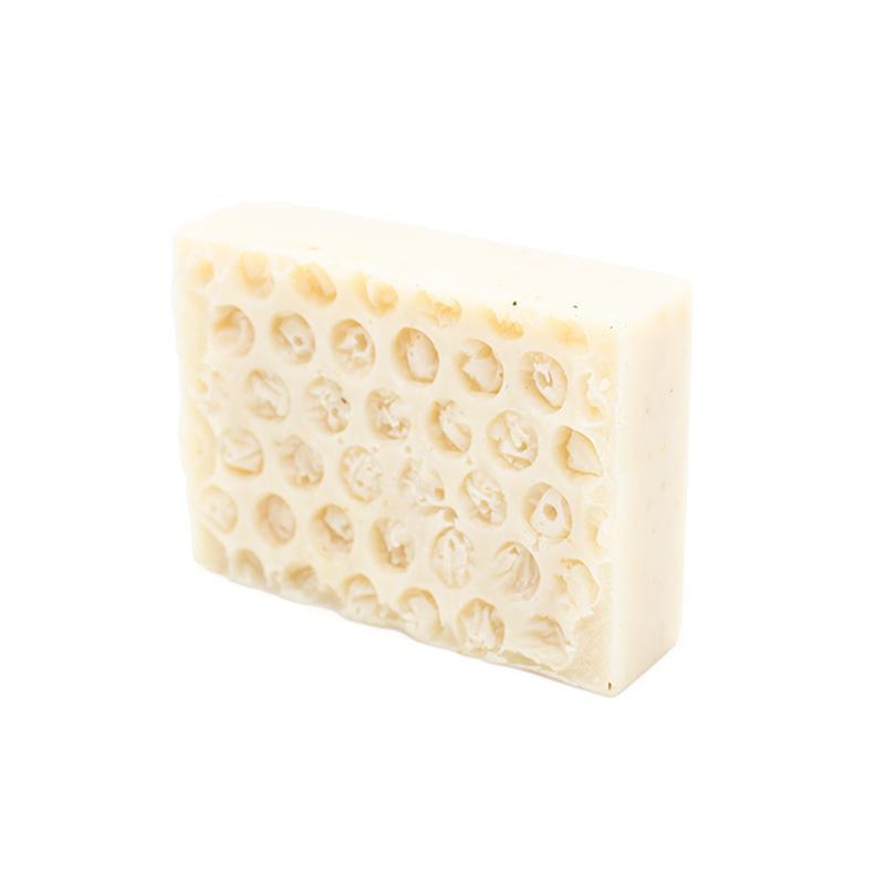 A 90g bar of 'Bee in your bonnet' Organic Soap featuring oats and honey, showcasing its natural ingredients and rich texture.