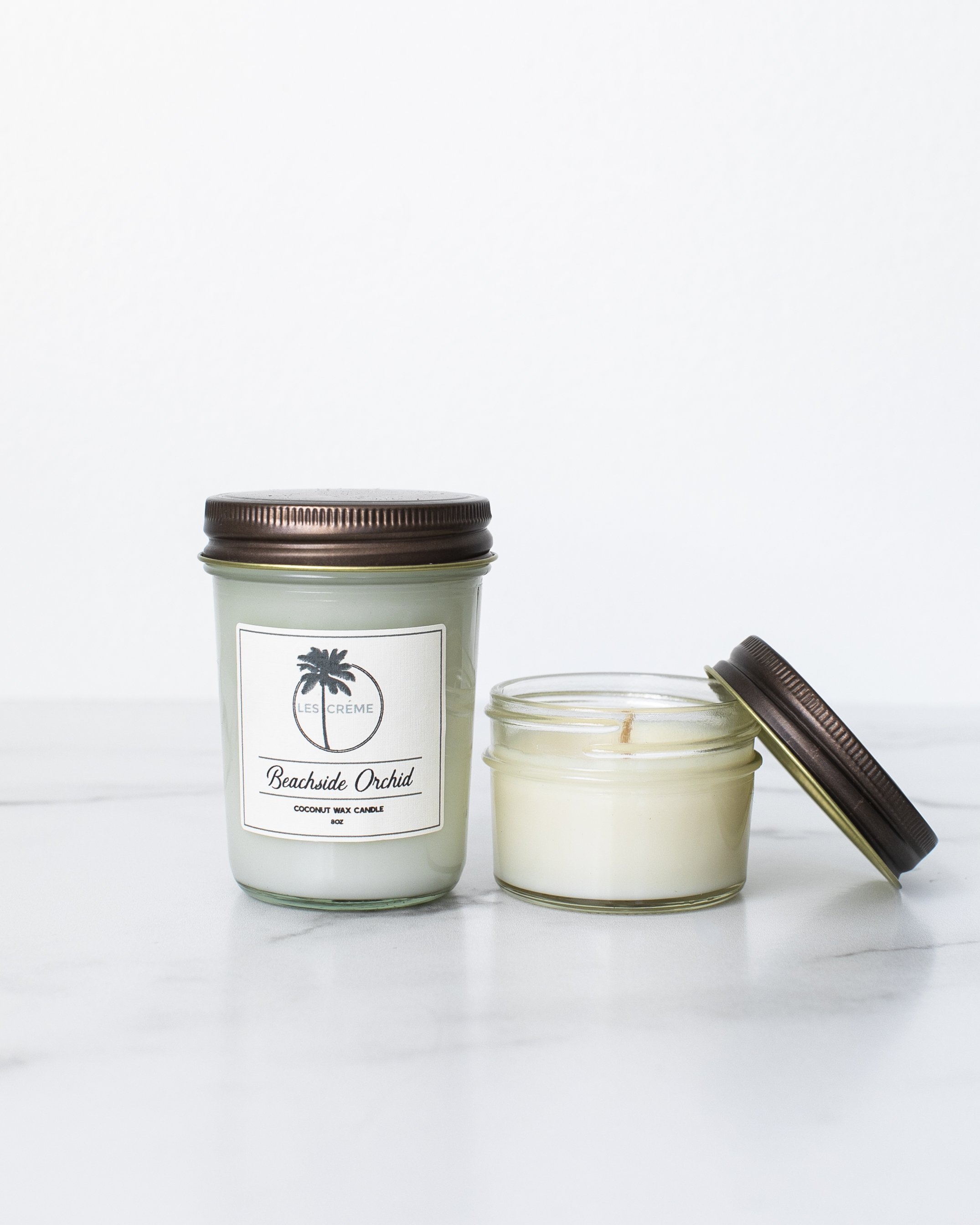 Beachside Orchid Scent Coconut Wax Candle in a stylish jar, showcasing its tropical design and natural ingredients.