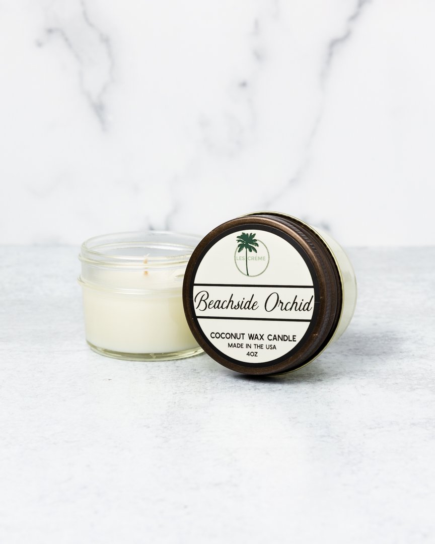 Beachside Orchid Scent Coconut Wax Candle in a stylish jar, showcasing its tropical design and natural ingredients.