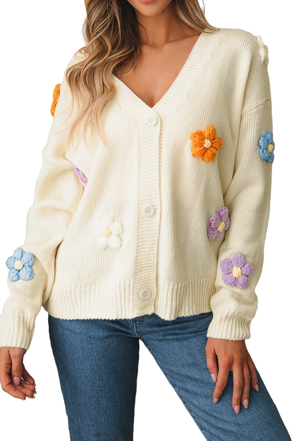 Beige cardigan sweater with colorful flower embellishments and button-up front, perfect for winter fashion.