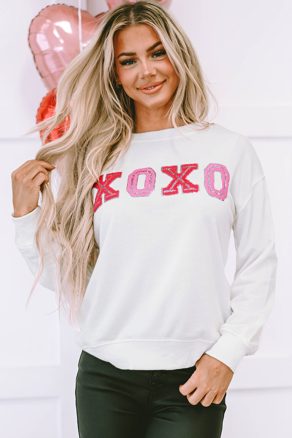 Beige pullover sweatshirt with shiny XOXO design, perfect for Valentine's Day celebrations.