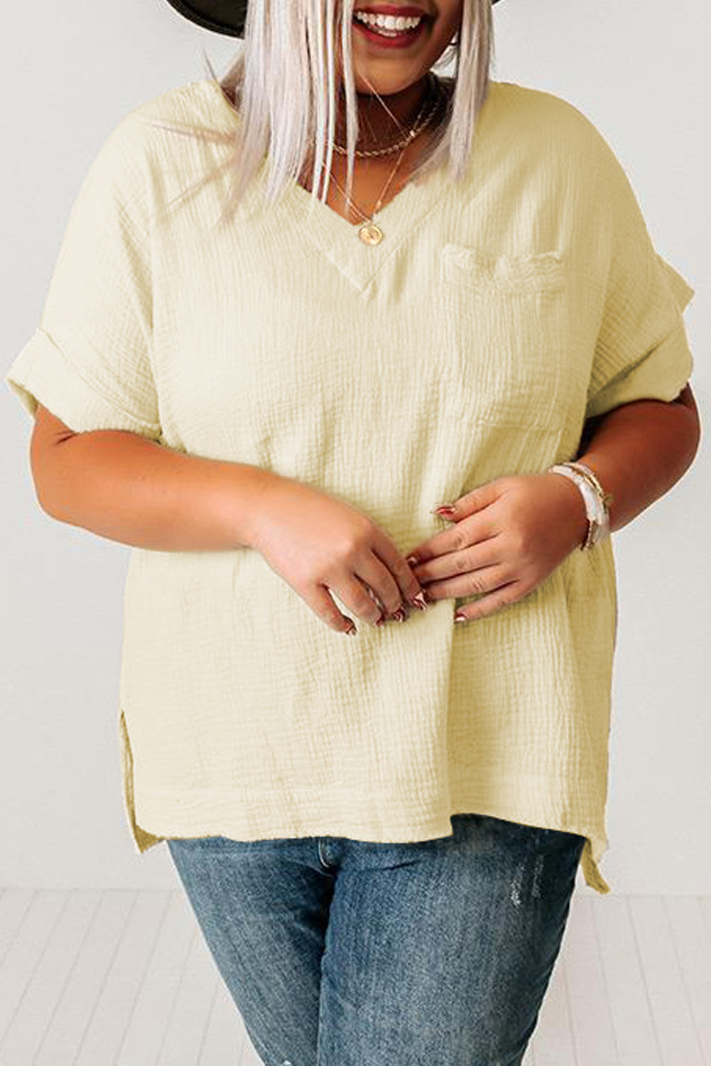 Beige Textured Pocket Split V Neck Plus Size Top featuring a v-neckline, short sleeves, and a single chest pocket.
