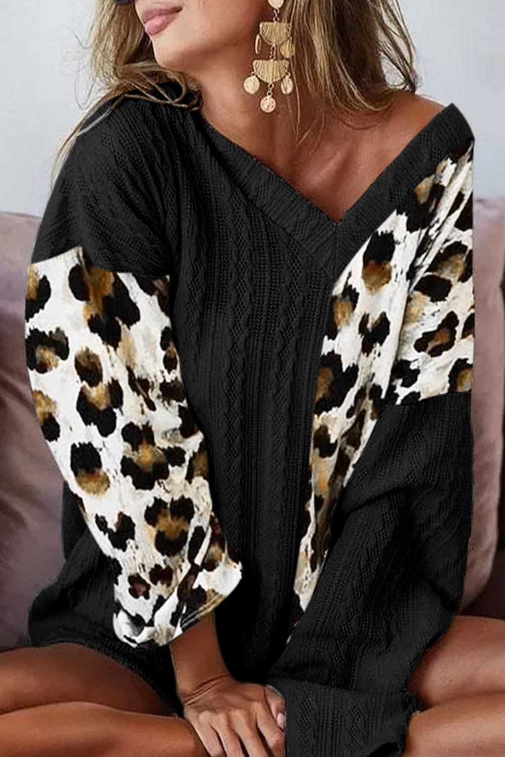 Black Asymmetric Leopard Patchwork Wide Sleeve V Neck Sweater showcasing a stylish design with leopard print splicing and wide sleeves.