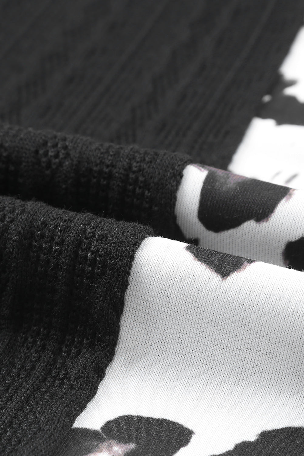 Black Asymmetric Leopard Patchwork Wide Sleeve V Neck Sweater showcasing a stylish design with leopard print splicing and wide sleeves.