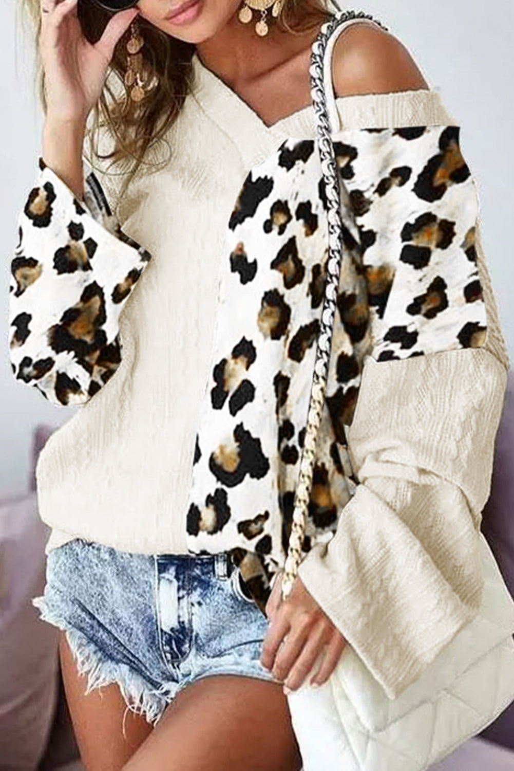 Black Asymmetric Leopard Patchwork Wide Sleeve V Neck Sweater showcasing a stylish design with leopard print splicing and wide sleeves.