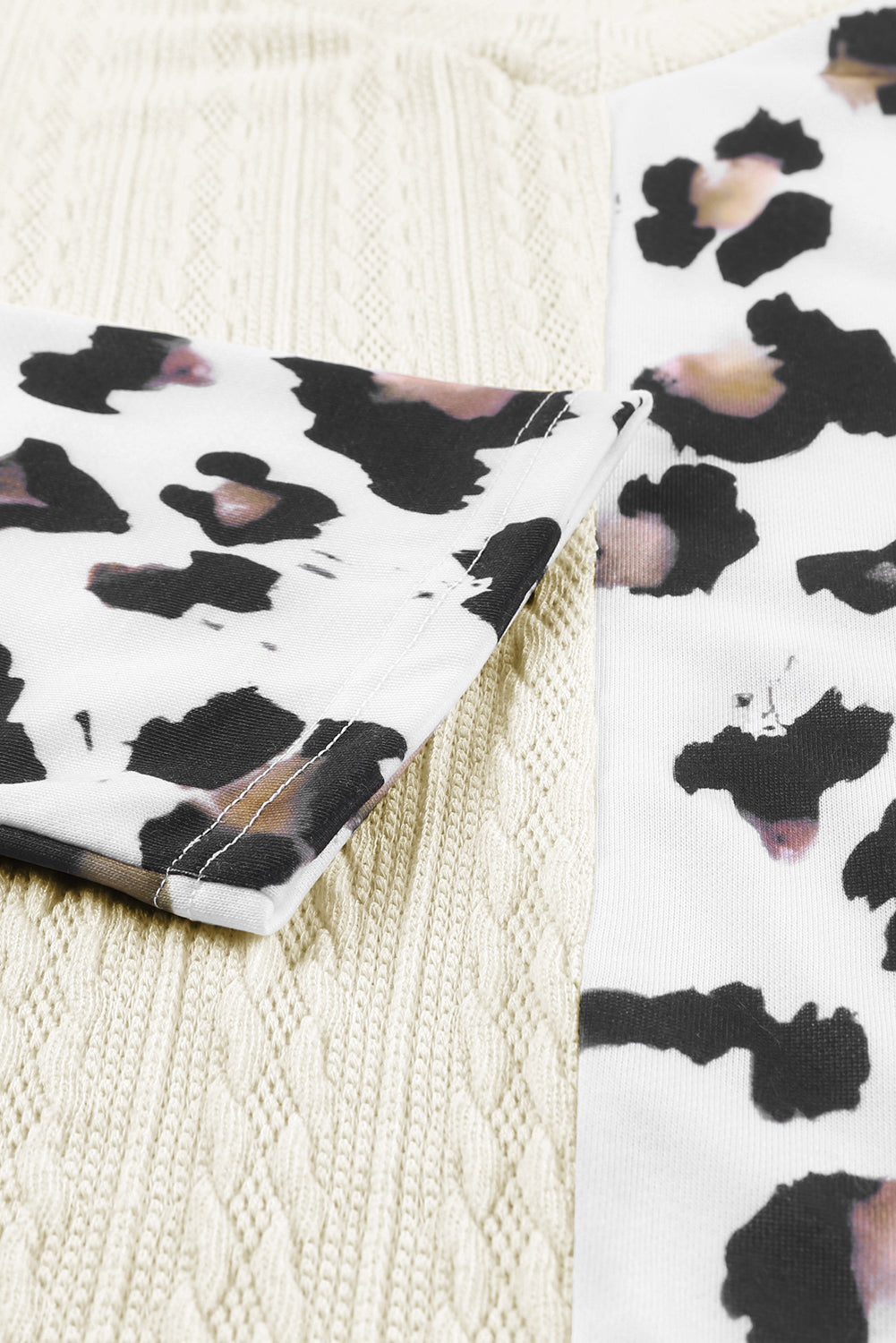 Black Asymmetric Leopard Patchwork Wide Sleeve V Neck Sweater showcasing a stylish design with leopard print splicing and wide sleeves.