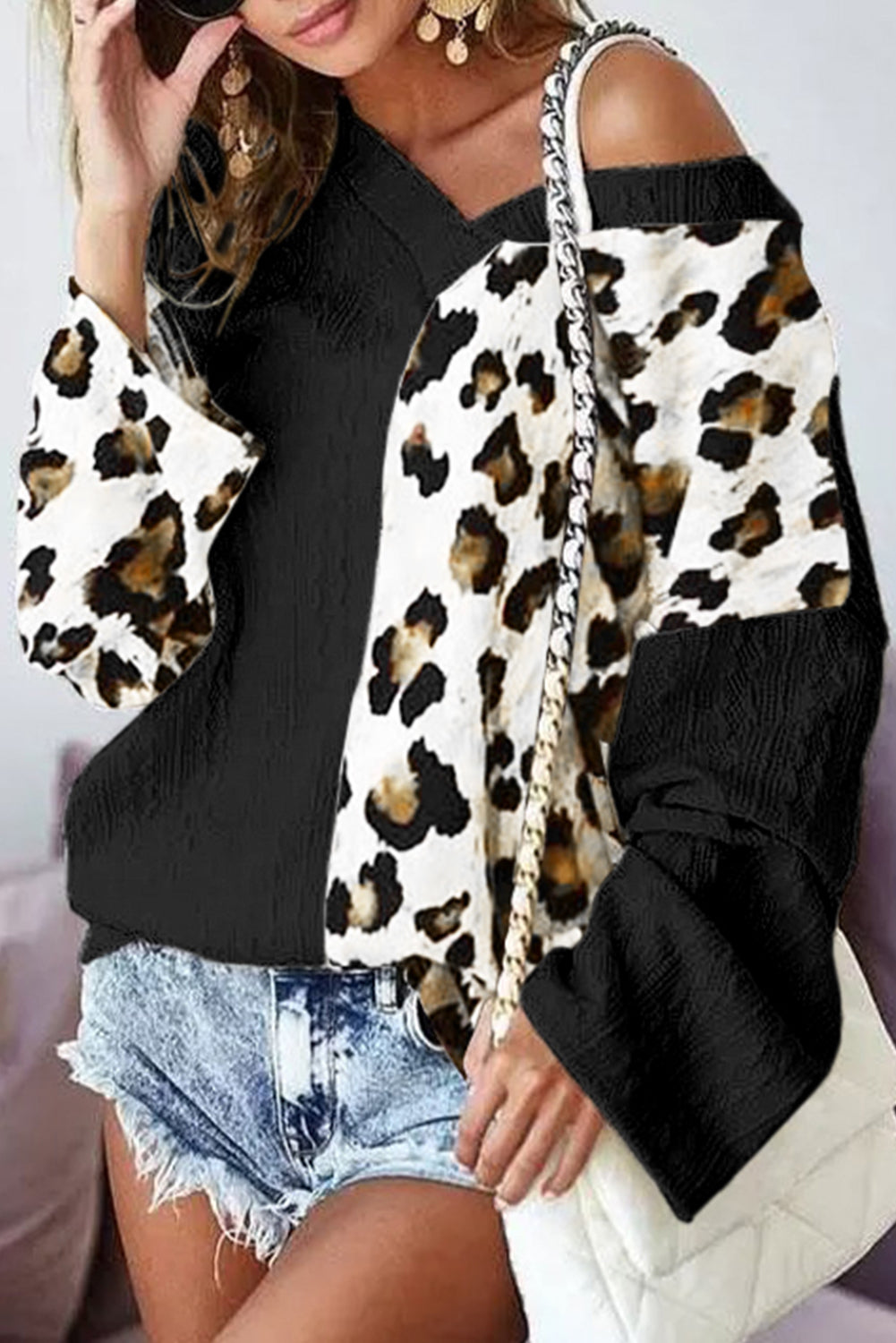 Black Asymmetric Leopard Patchwork Wide Sleeve V Neck Sweater showcasing a stylish design with leopard print splicing and wide sleeves.