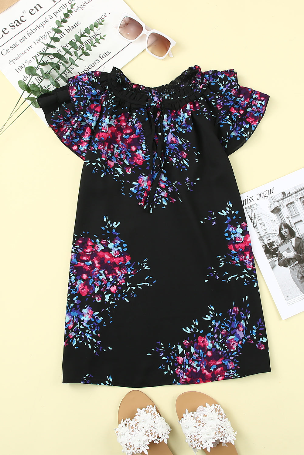 Black blouse with butterfly sleeves and split V-neck, featuring a colorful tie-dye print, perfect for stylish women.