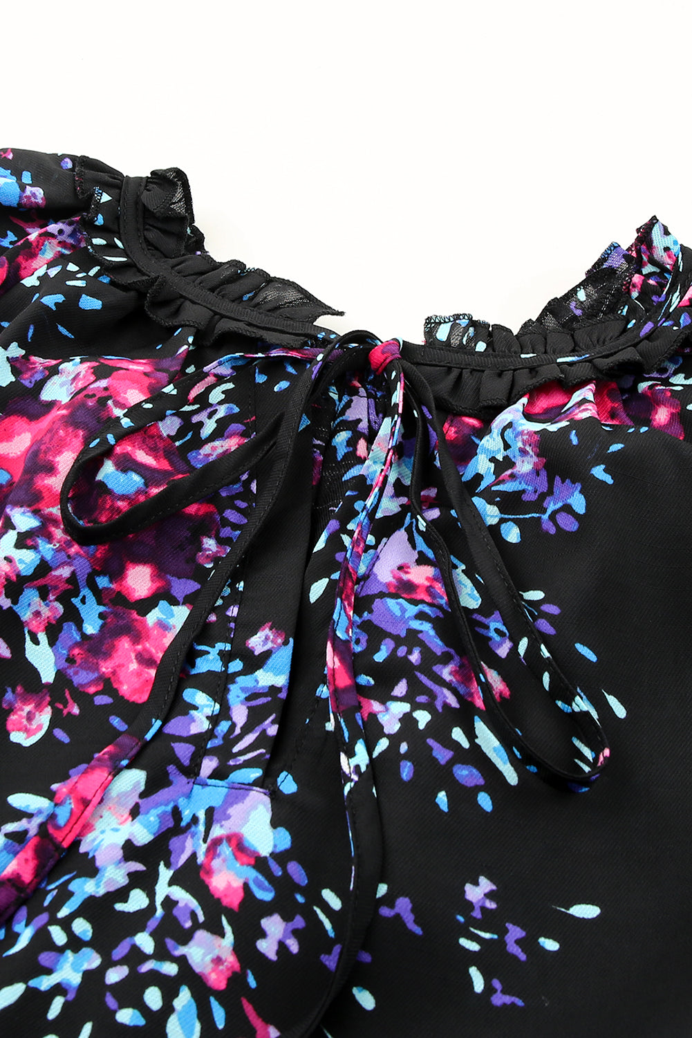 Black blouse with butterfly sleeves and split V-neck, featuring a colorful tie-dye print, perfect for stylish women.