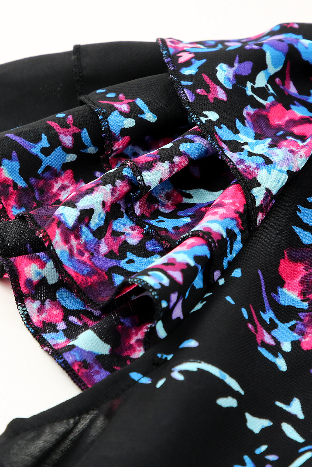 Black blouse with butterfly sleeves and split V-neck, featuring a colorful tie-dye print, perfect for stylish women.