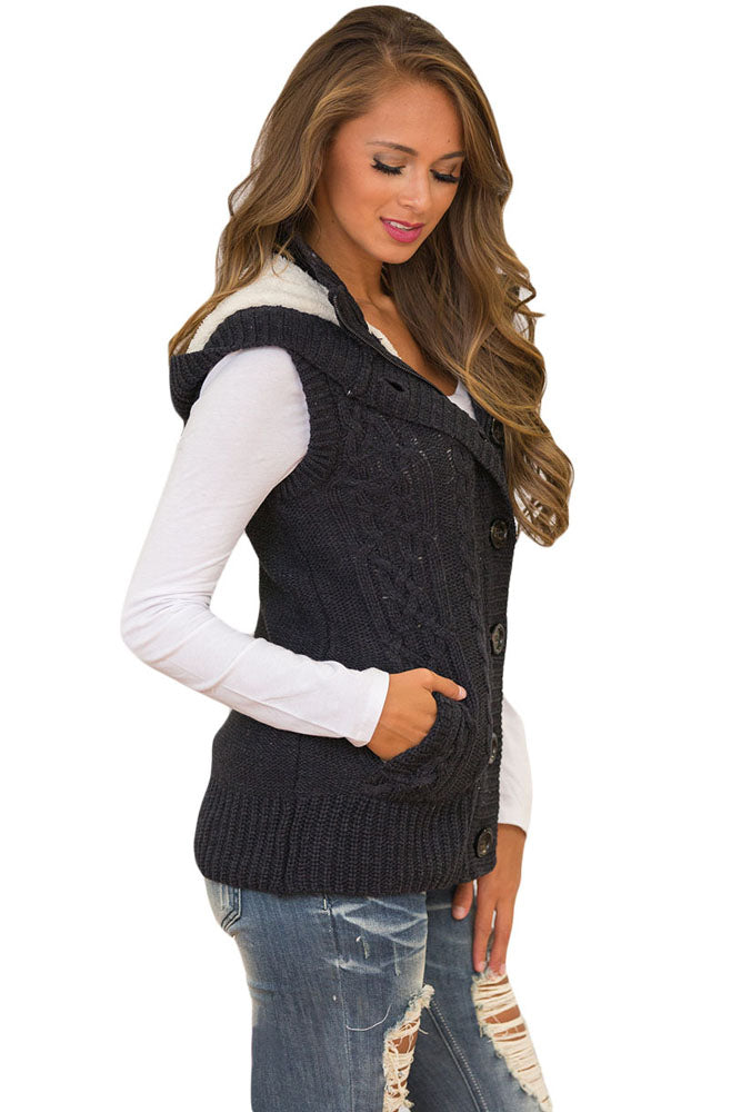 A stylish black cable knit hooded sweater vest featuring a zip front, decorative buttons, and fleece-lined hood, perfect for layering.