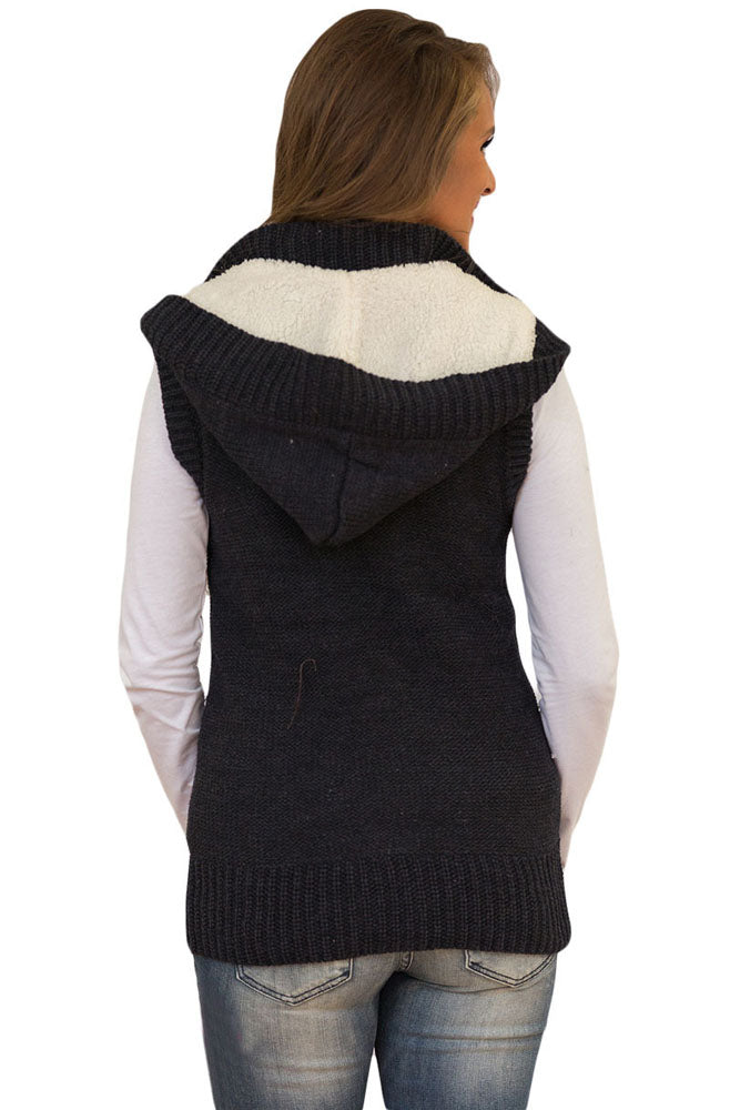 A stylish black cable knit hooded sweater vest featuring a zip front, decorative buttons, and fleece-lined hood, perfect for layering.