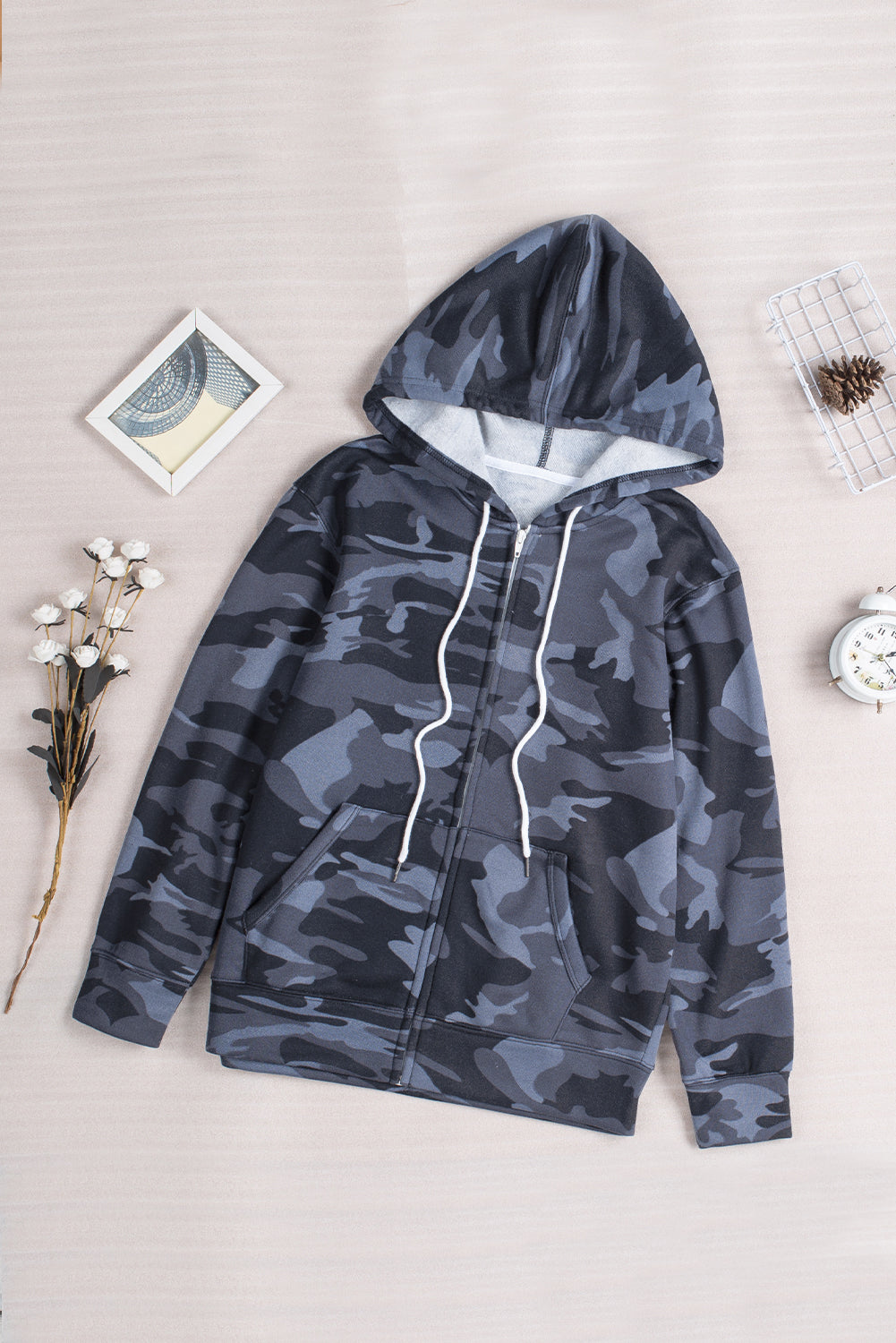 Black camo print zip-up hooded coat with pockets, showcasing a stylish design suitable for casual wear.