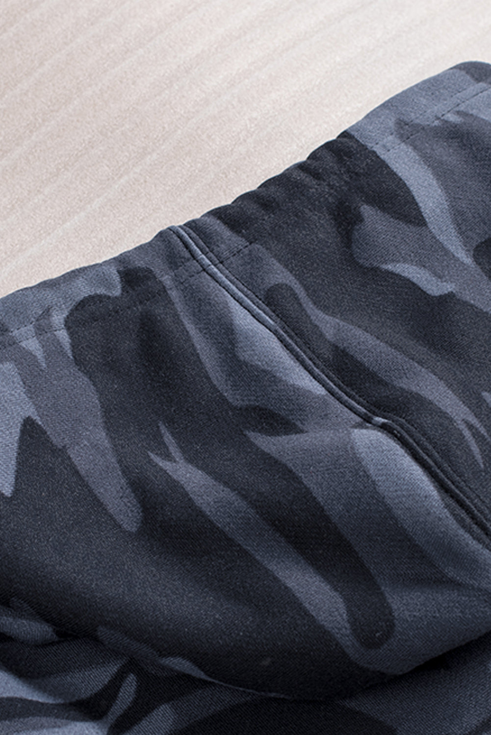 Black camo print zip-up hooded coat with pockets, showcasing a stylish design suitable for casual wear.