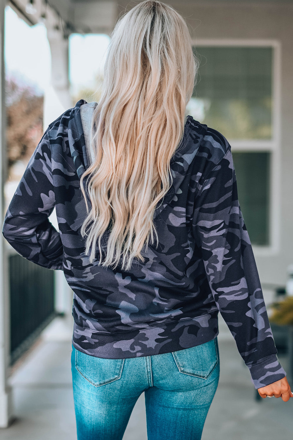 Black camo print zip-up hooded coat with pockets, showcasing a stylish design suitable for casual wear.