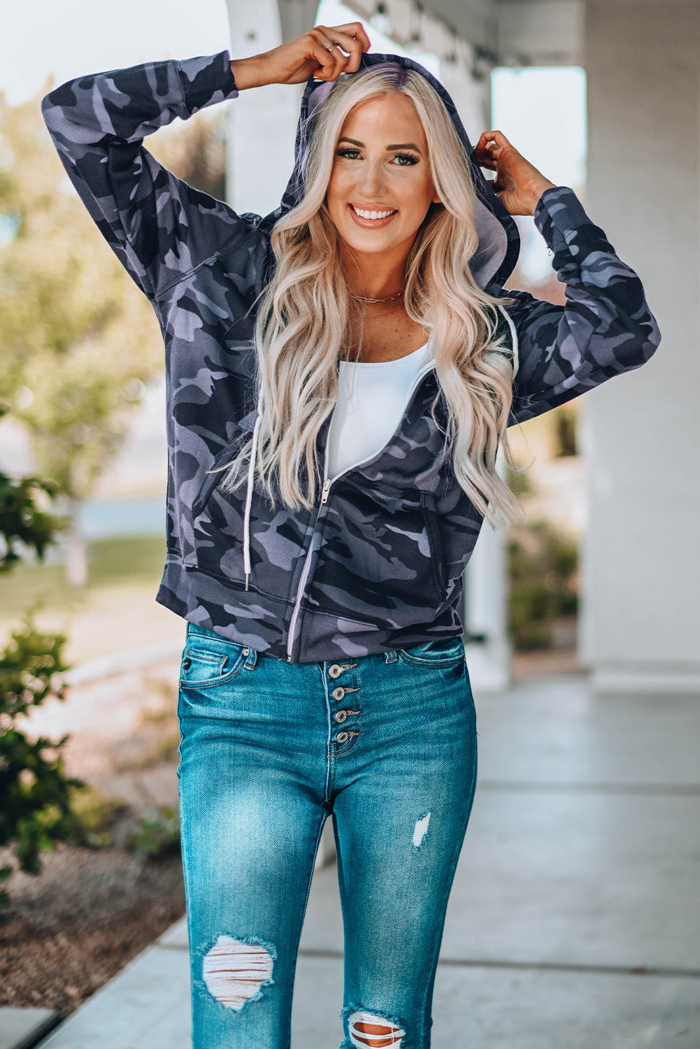 Black camo print zip-up hooded coat with pockets, showcasing a stylish design suitable for casual wear.