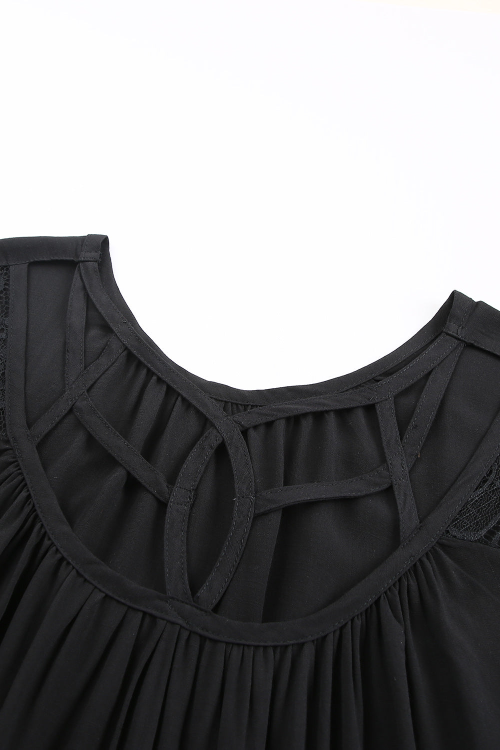 Black short sleeve top featuring cut-out design and lace patchwork, perfect for stylish casual wear.