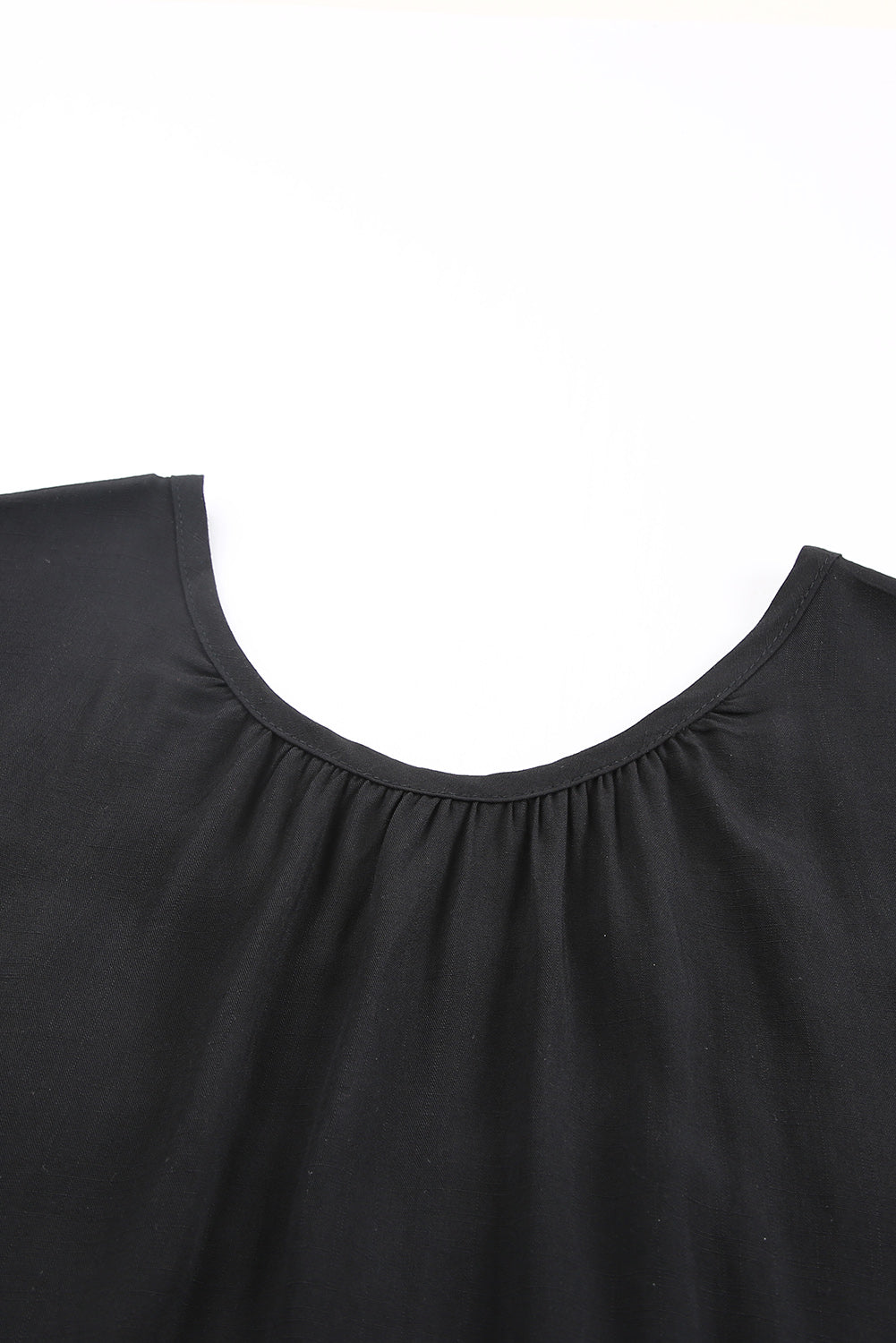 Black short sleeve top featuring cut-out design and lace patchwork, perfect for stylish casual wear.