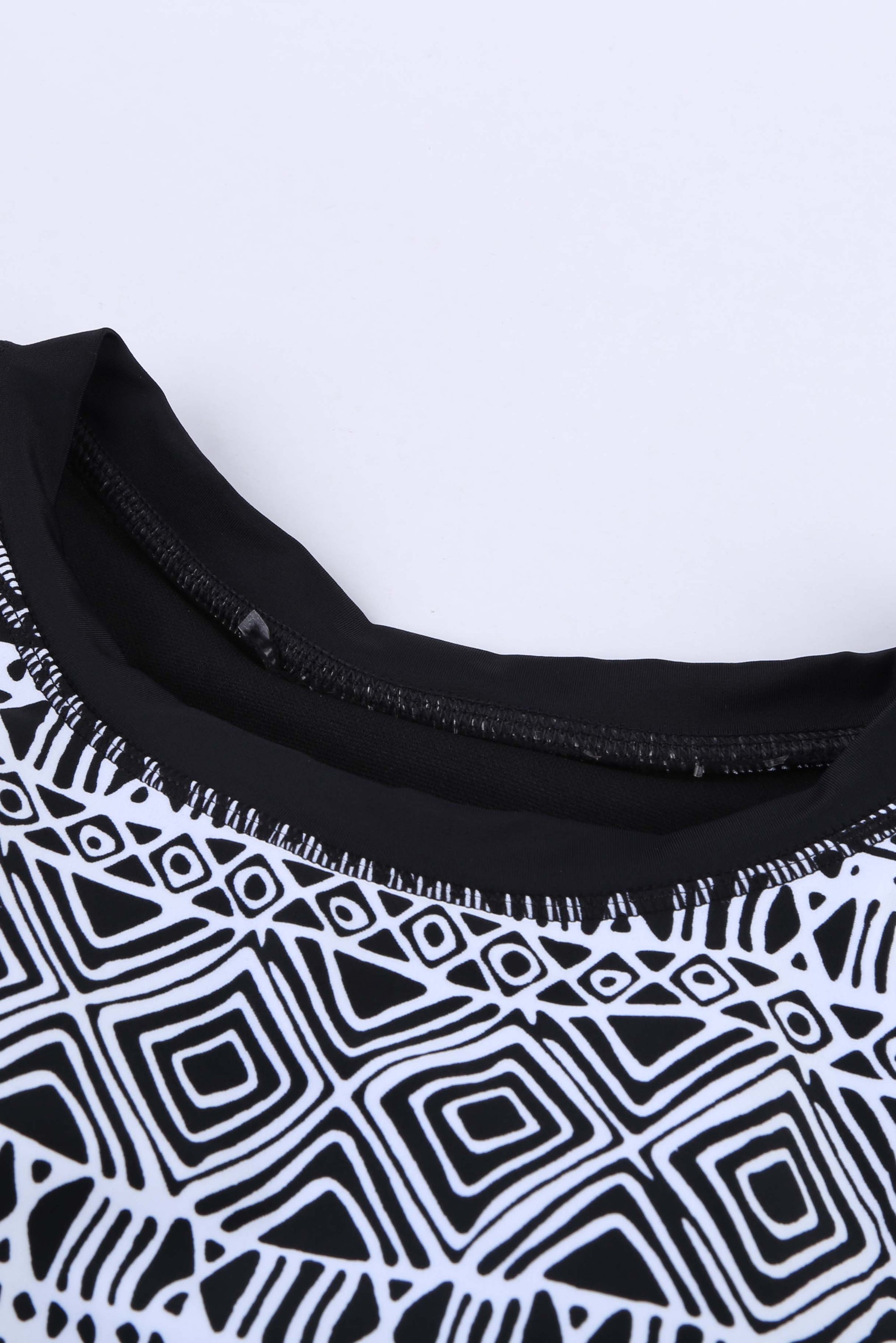 Black ethnic print high neck strappy tankini top designed for stylish swimwear with body shaping control.