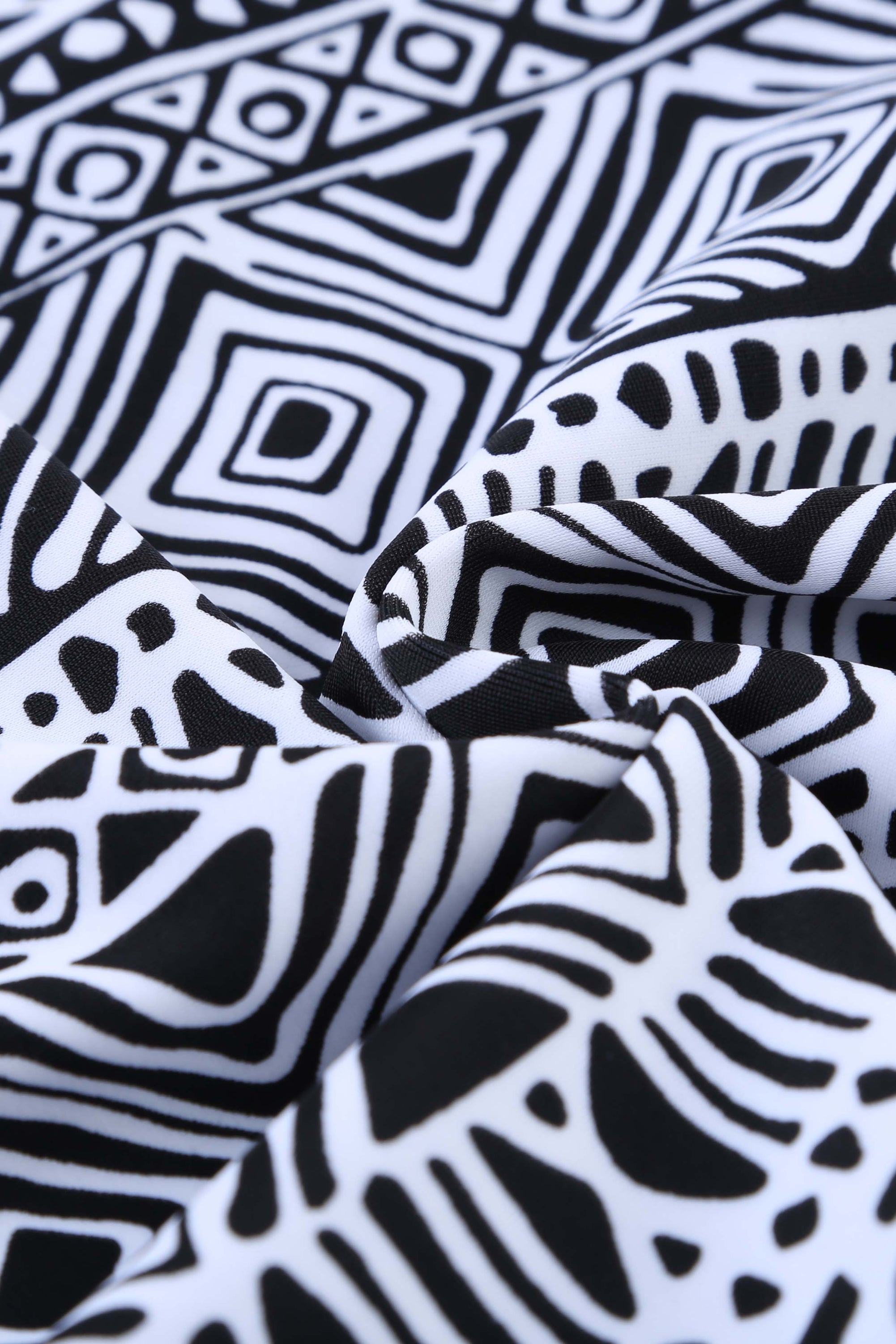 Black ethnic print high neck strappy tankini top designed for stylish swimwear with body shaping control.