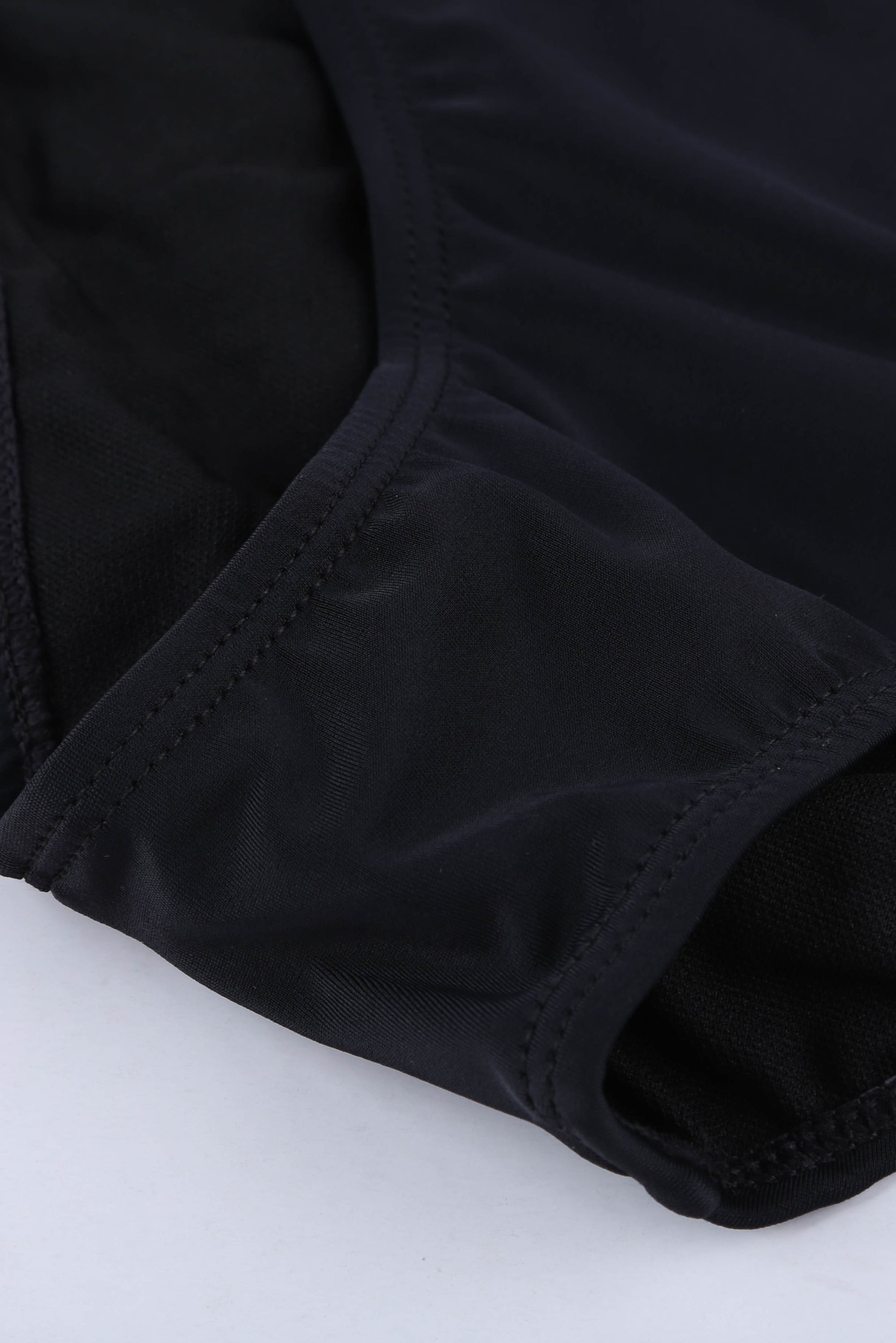 Black ethnic print high neck strappy tankini top designed for stylish swimwear with body shaping control.