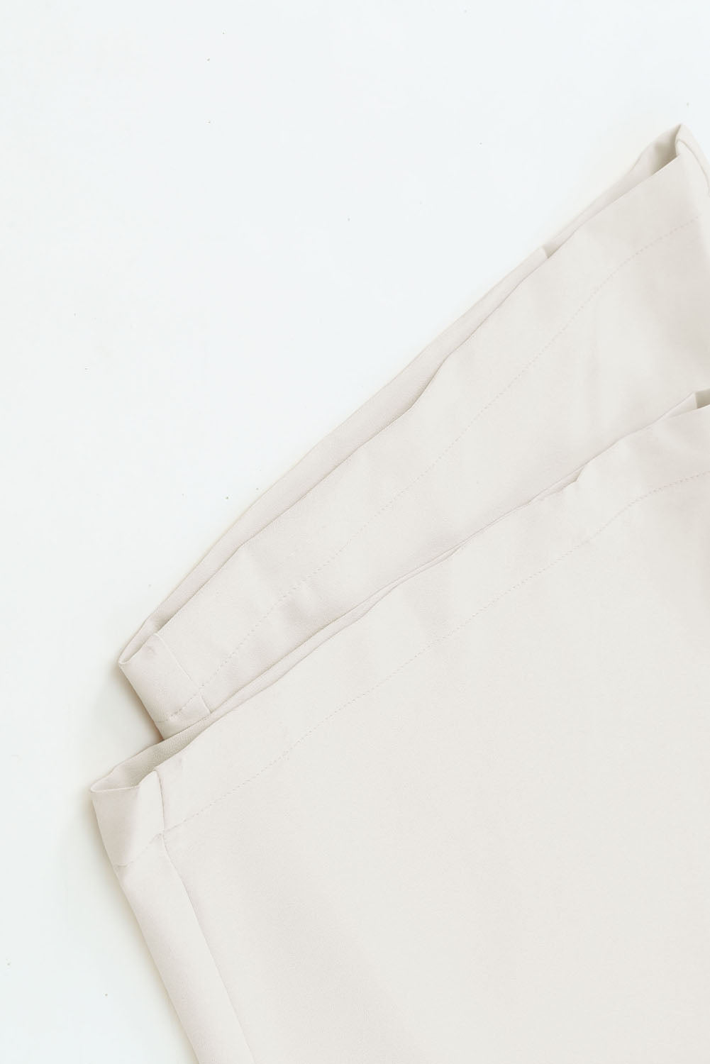 A stylish black jumpsuit featuring flutter sleeves, a smocked bodice, and wide leg bottoms, perfect for any occasion.