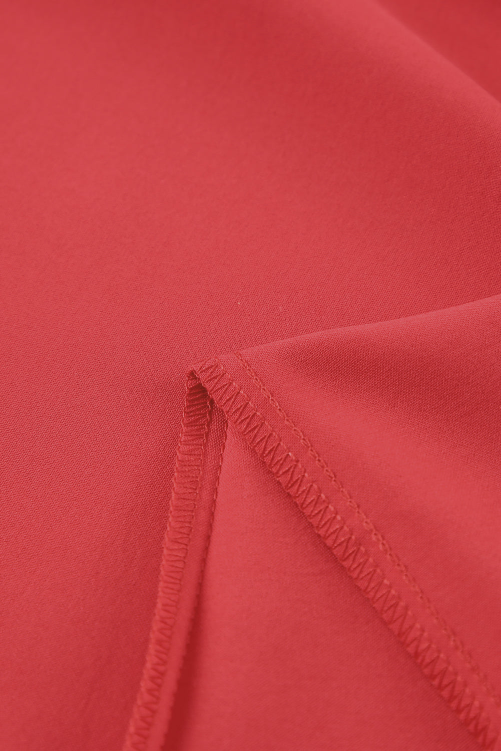 A stylish black jumpsuit featuring flutter sleeves, a smocked bodice, and wide leg bottoms, perfect for any occasion.