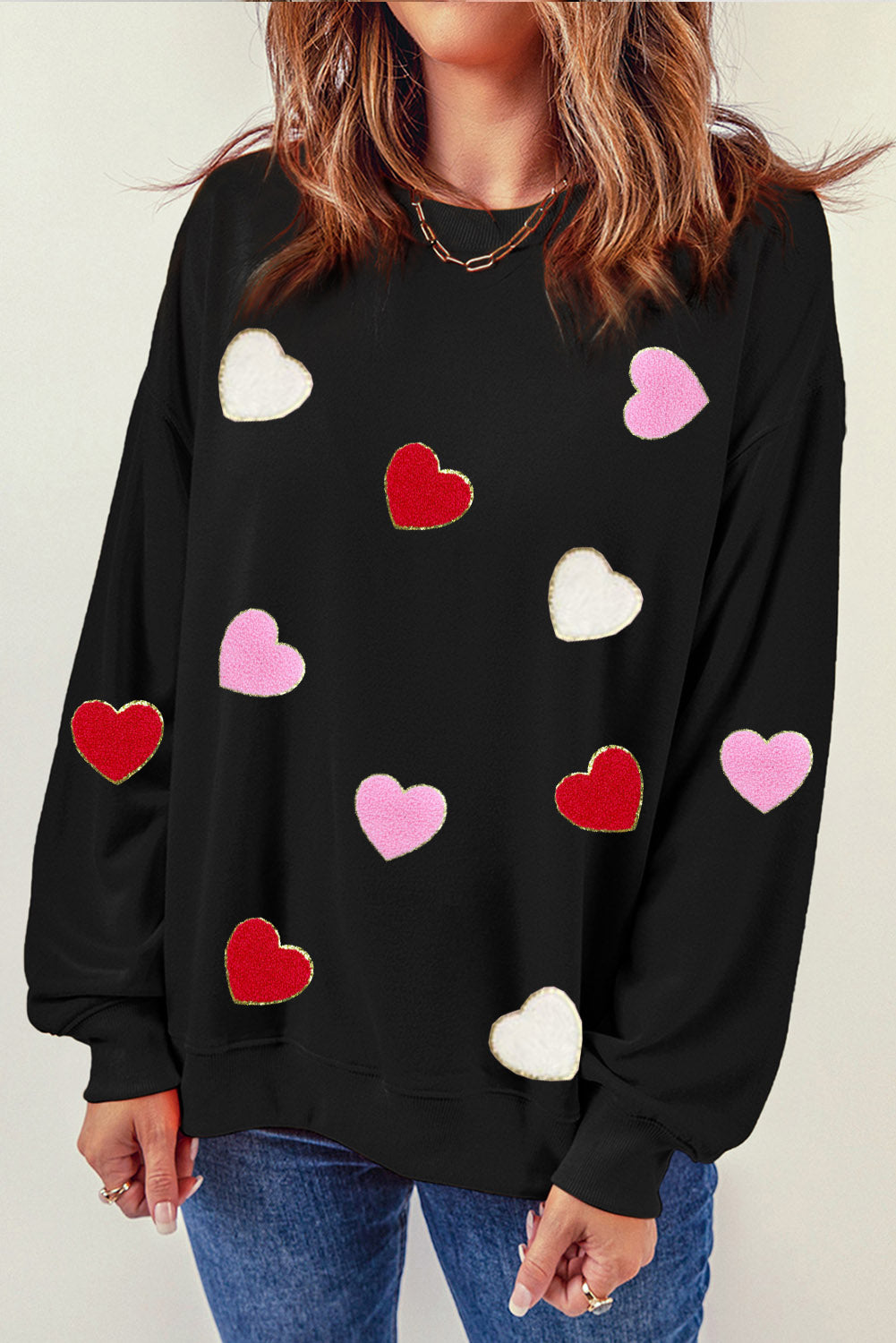 Black crew neck sweatshirt featuring heart-shaped chenille embroidery, showcasing a stylish and cozy design.