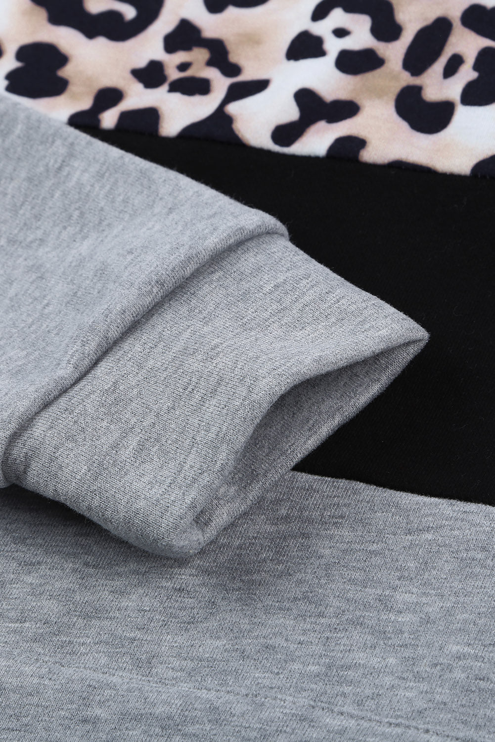 Black Leopard Splicing Kangaroo Pocket Drawstring Hoodie featuring camouflage and leopard print design with a wide neckline and kangaroo pocket.