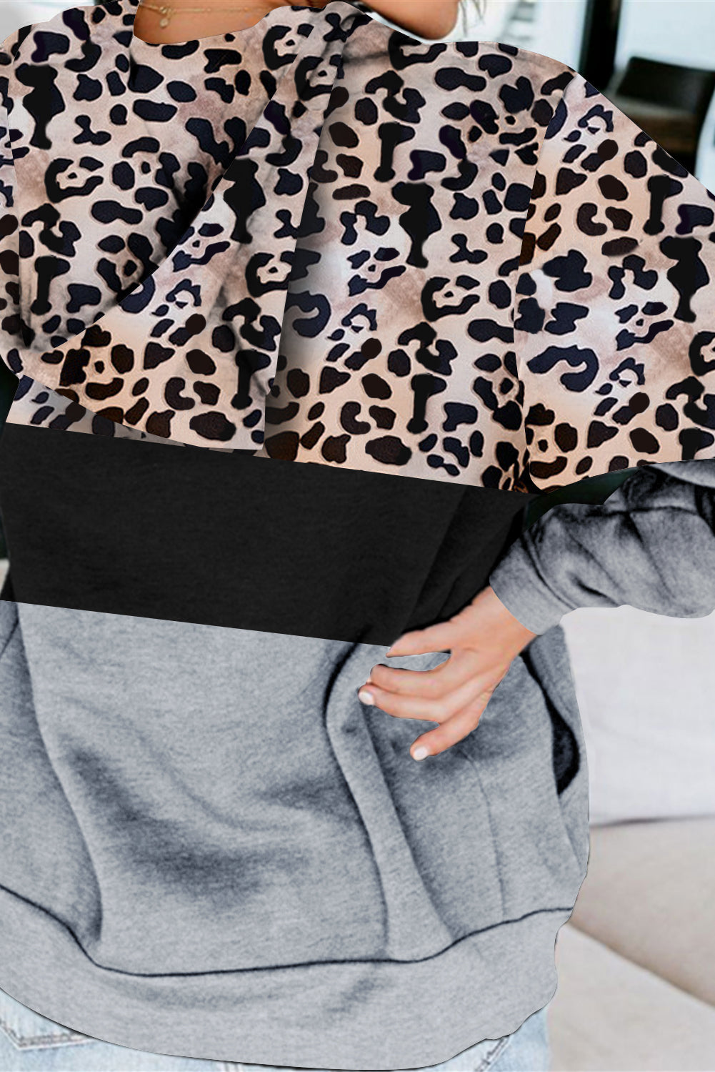 Black Leopard Splicing Kangaroo Pocket Drawstring Hoodie featuring camouflage and leopard print design with a wide neckline and kangaroo pocket.