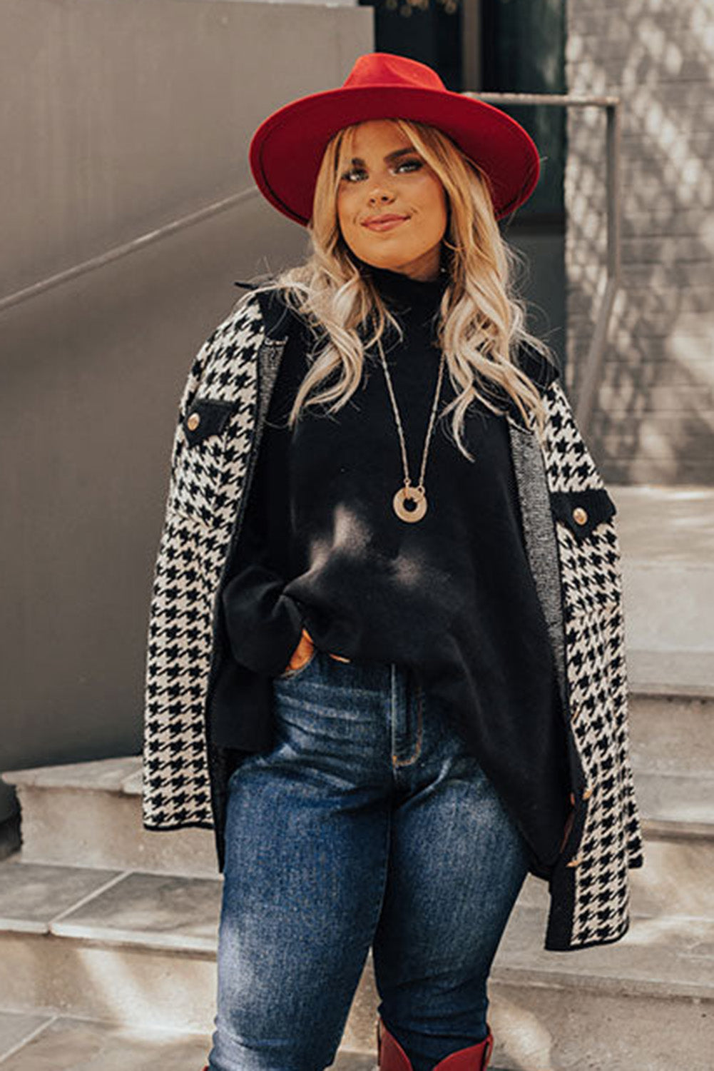 Black plus size loose sweater with side slits and high neck design, showcasing a relaxed fit and stylish look.