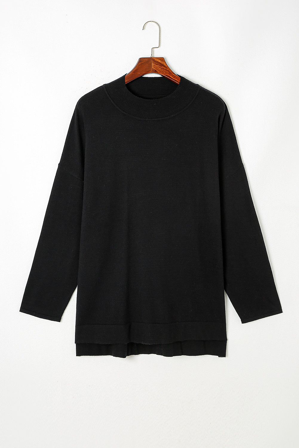Black plus size loose sweater with side slits and high neck design, showcasing a relaxed fit and stylish look.