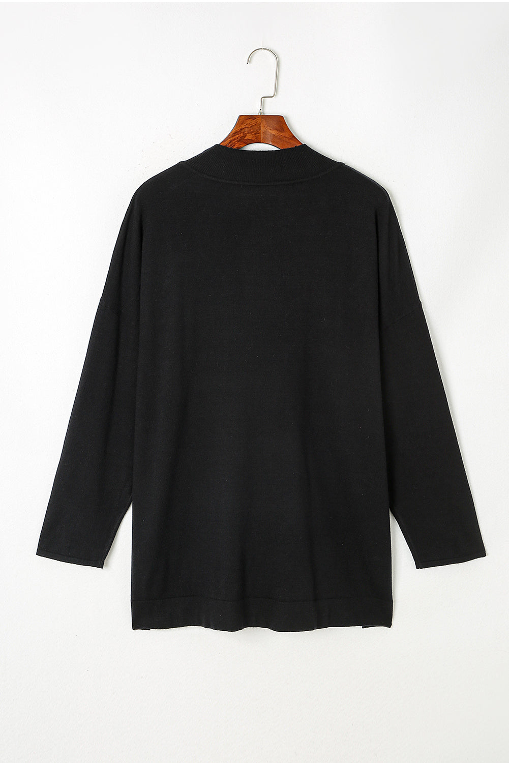 Black plus size loose sweater with side slits and high neck design, showcasing a relaxed fit and stylish look.