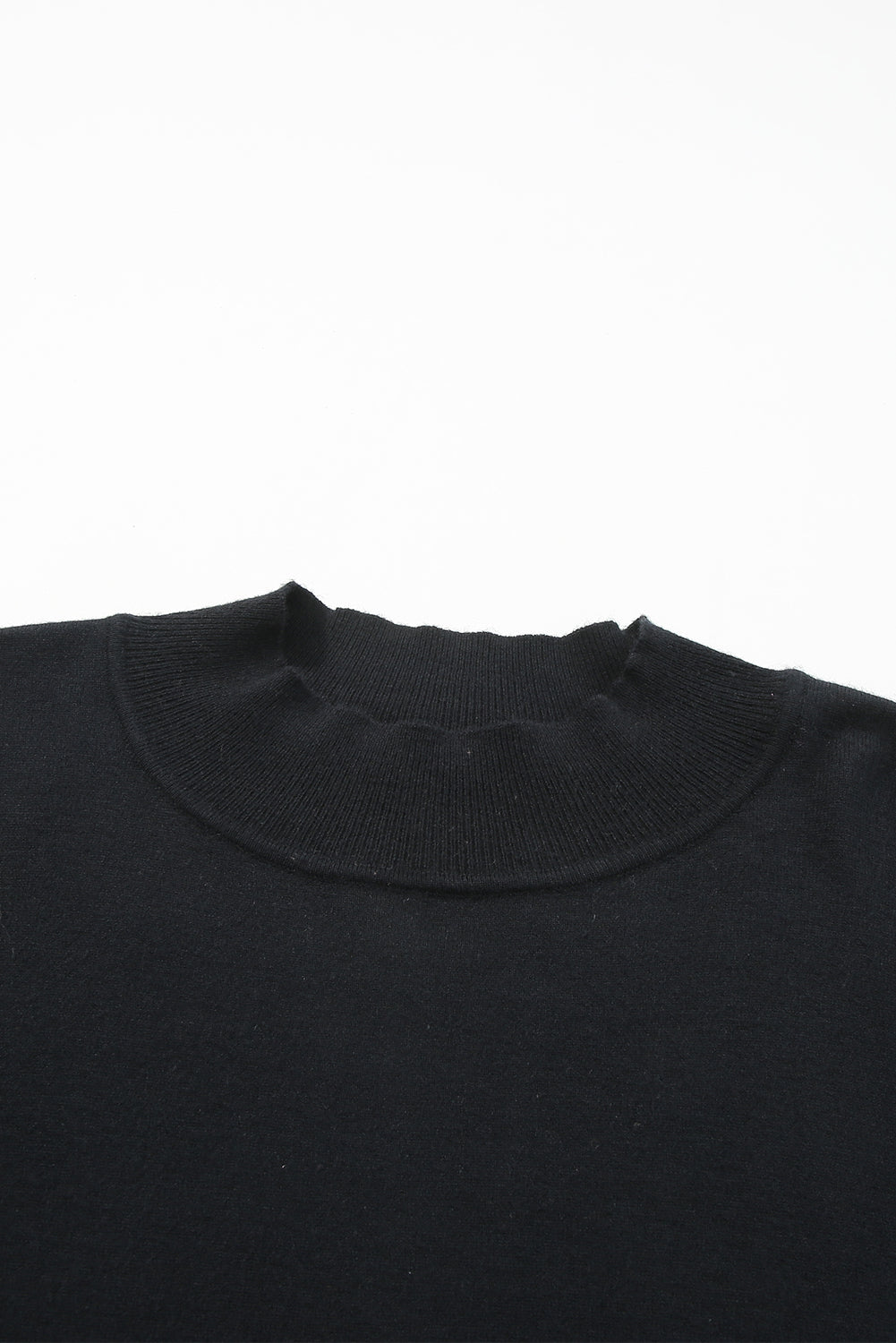 Black plus size loose sweater with side slits and high neck design, showcasing a relaxed fit and stylish look.