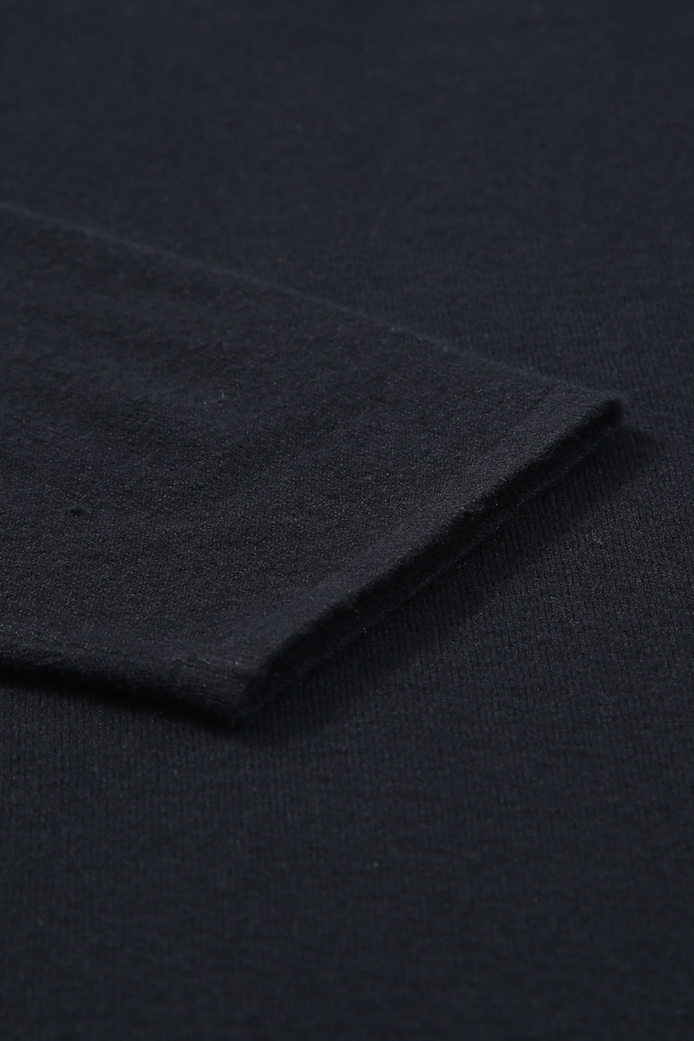 Black plus size loose sweater with side slits and high neck design, showcasing a relaxed fit and stylish look.