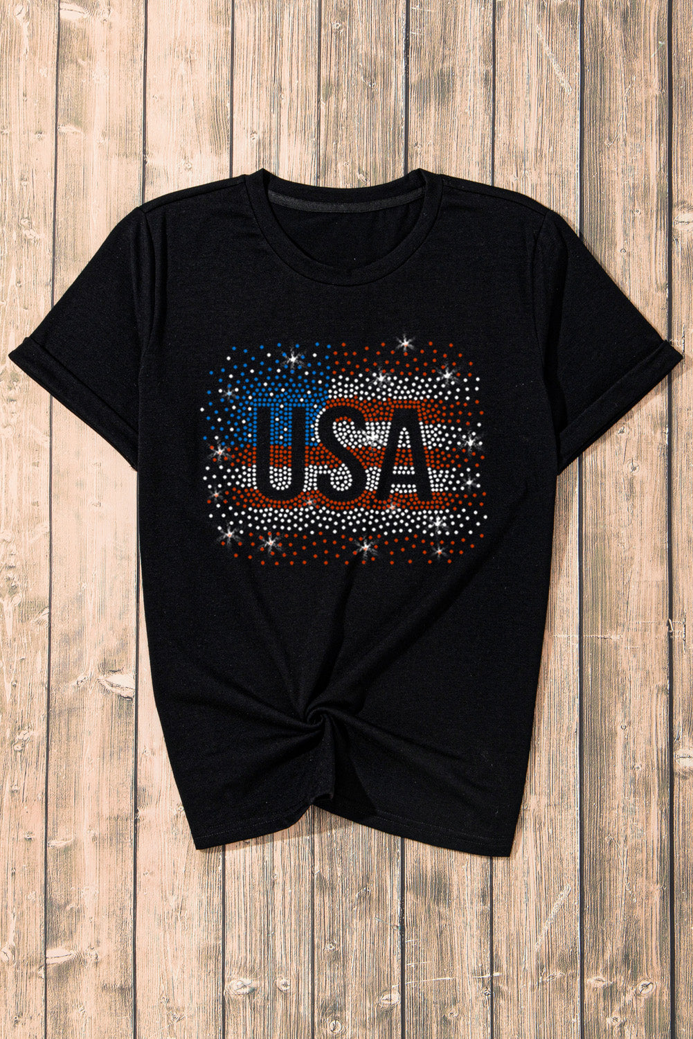 Black t-shirt featuring a rhinestone graphic of the American flag, showcasing a stylish patriotic design.
